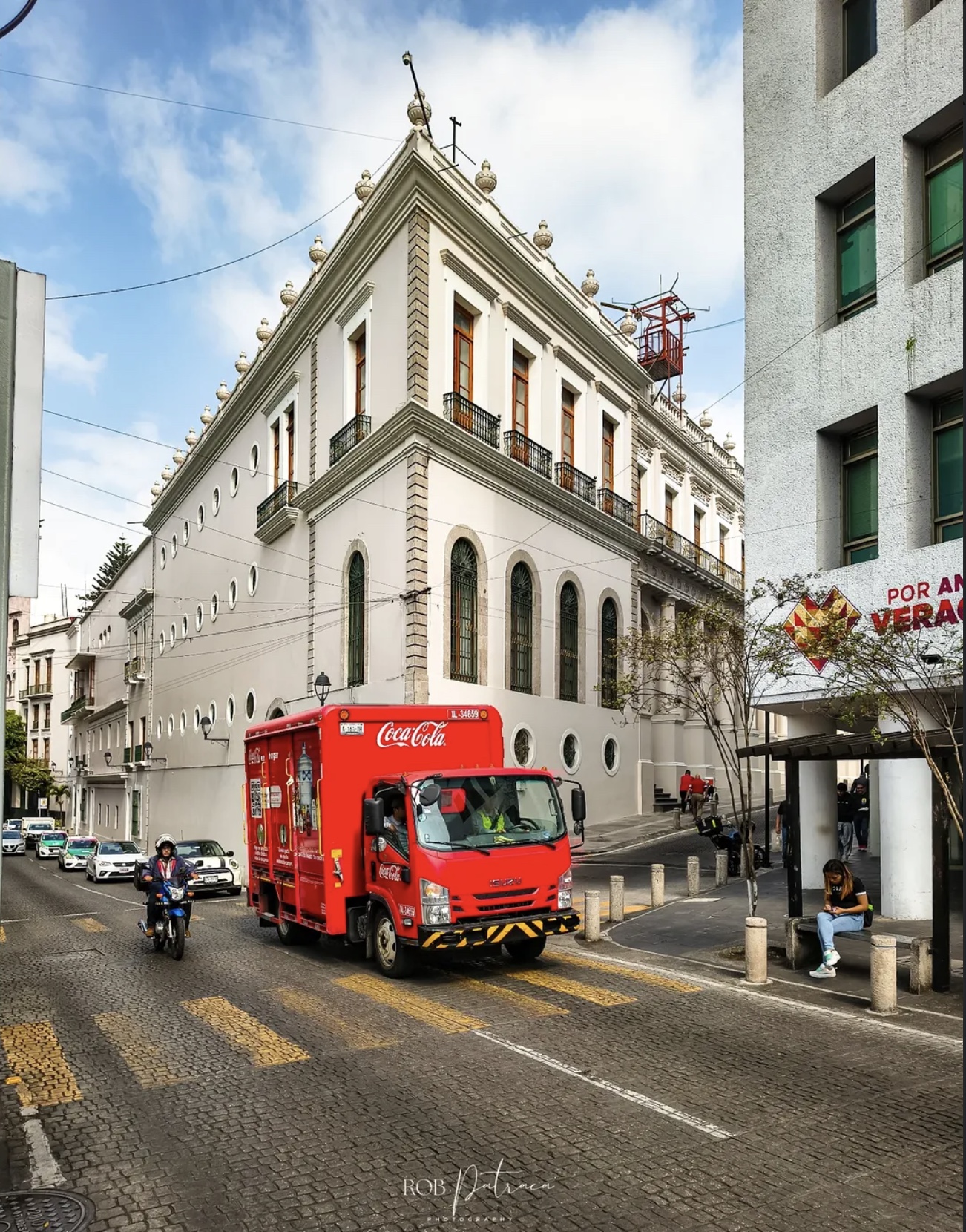 Colonial building on cobblestone street with Coca-Cola delivery truck