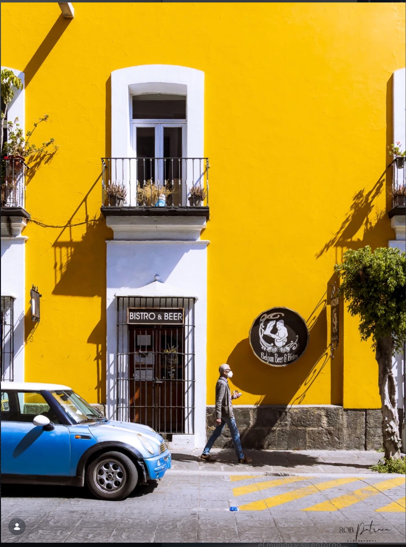 Colorful yellow bistro facade with Mini Cooper